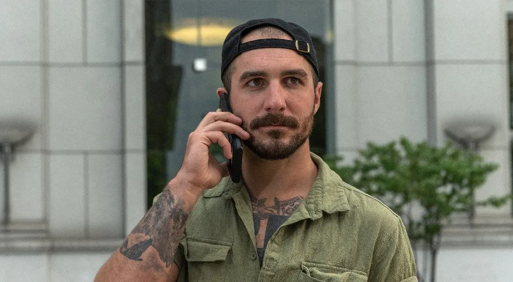 Article image: a Veteran taking a phone call outside.