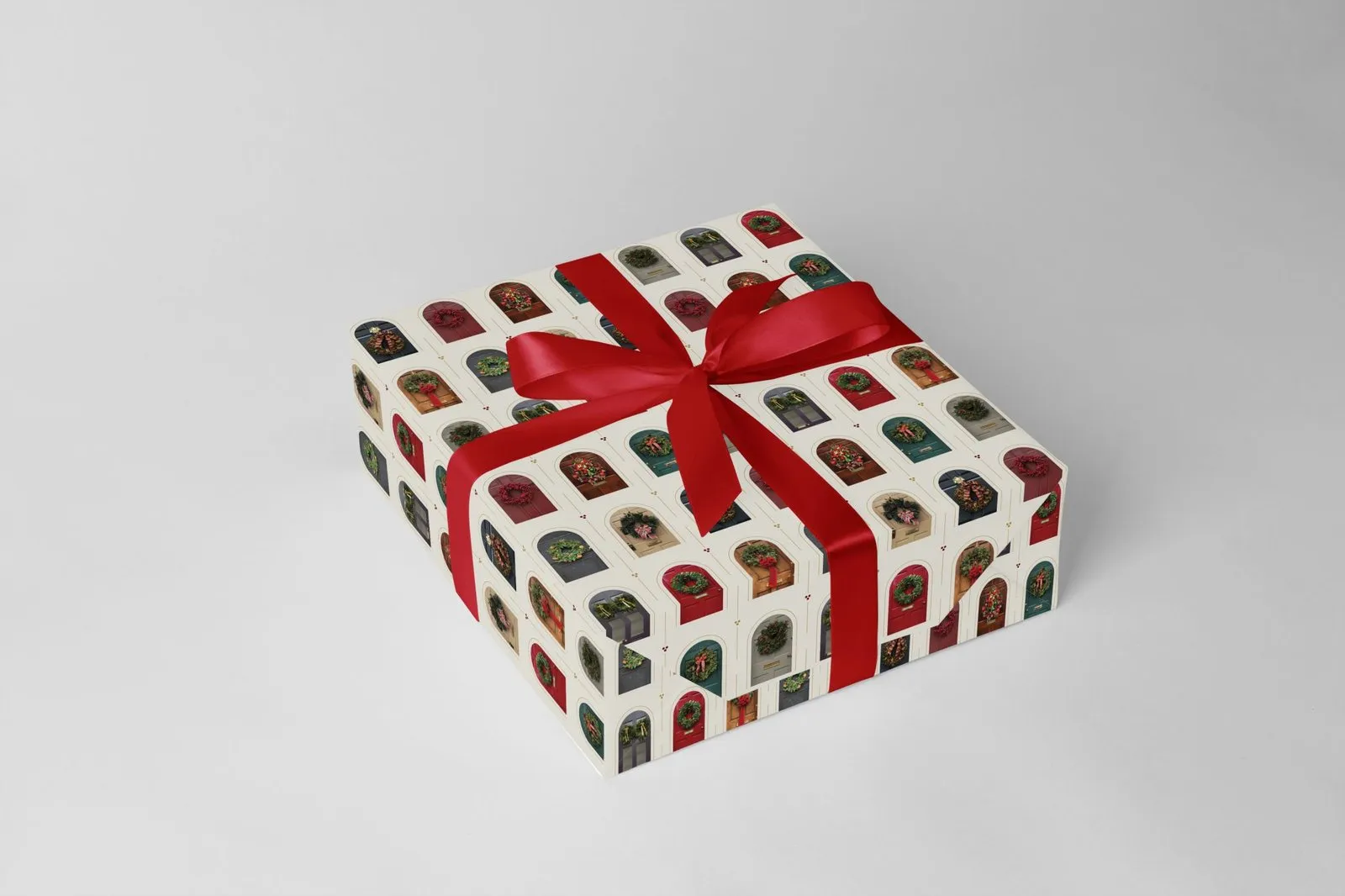 A gift box wrapped in the front-door pattern and tied with a red ribbon.
